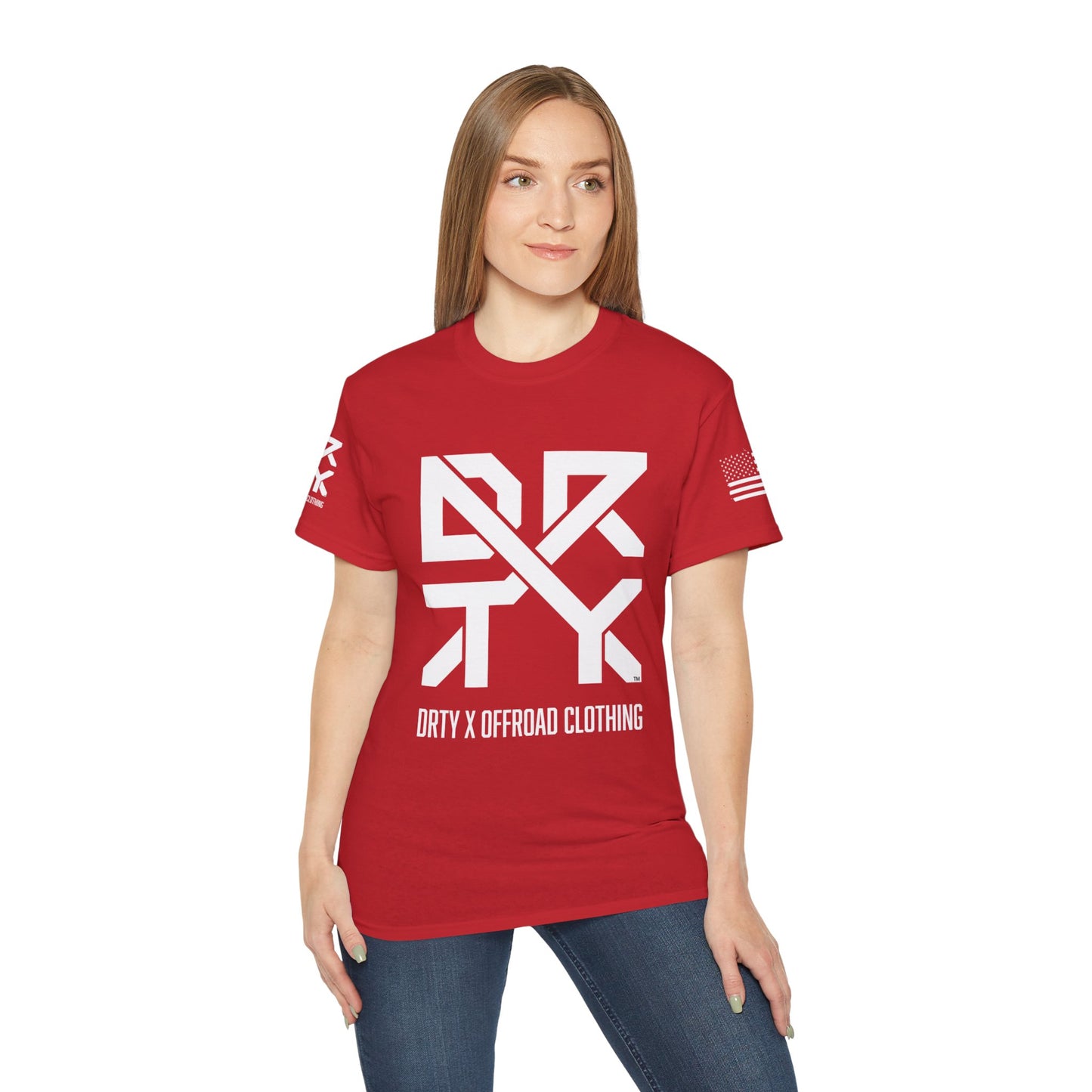 This image showcases the front view of a woman wearing a T-shirt with a DRTY X Logo on the center of the T Shirt and on the right sleeve. The right sleeve has an American flag.