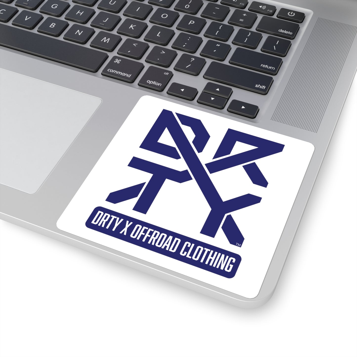 This image shows a small square DRTY X Logo sticker on a laptop background.