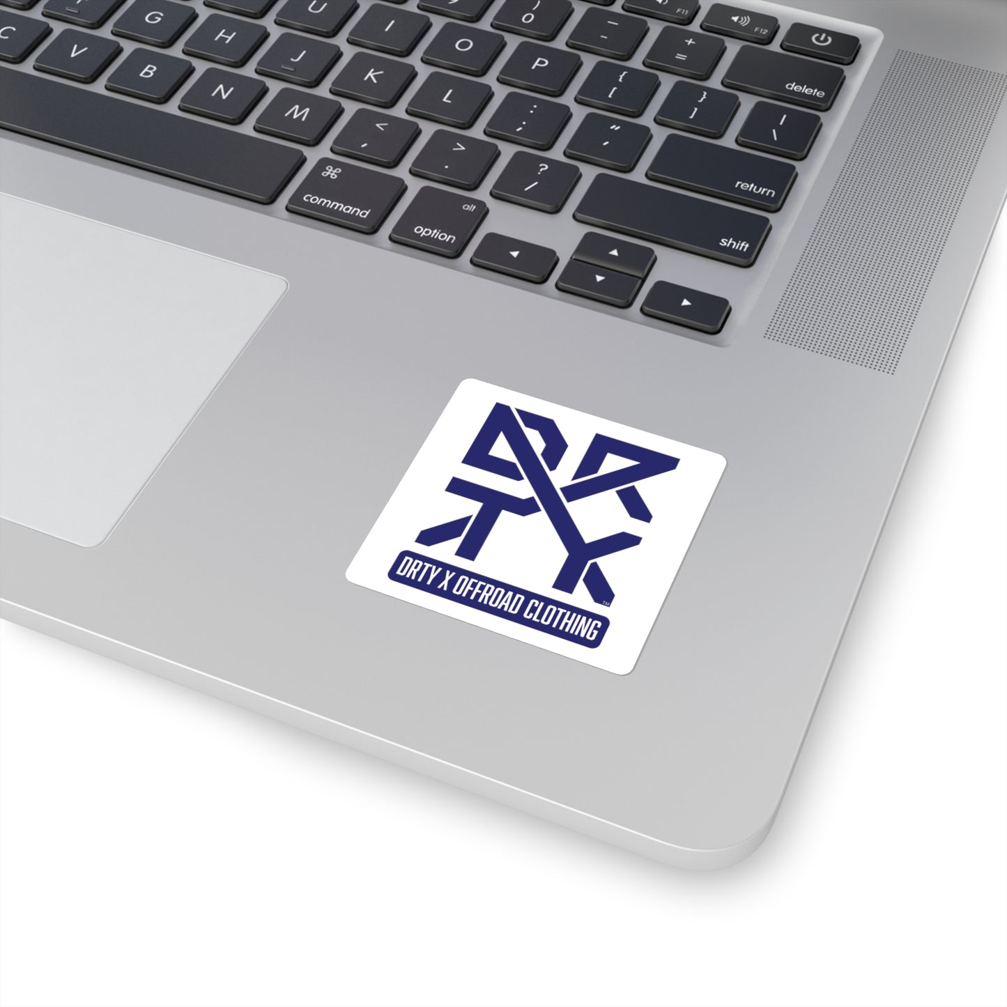 This image shows a small square DRTY X Logo sticker on a laptop background.