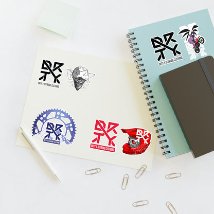 This image shows a small DRTY X Logo and artwork sticker on a notepad,and sticker sheet on a table.